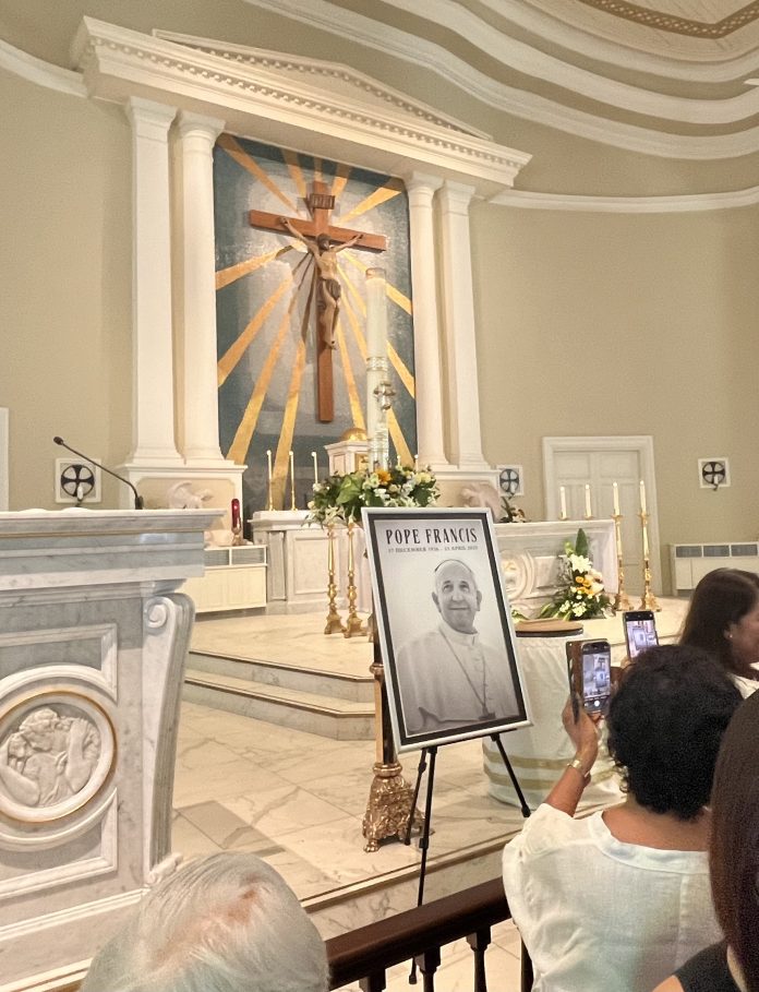 CATHOLICS TAKE PHOTO OF POPE PORTRAIT